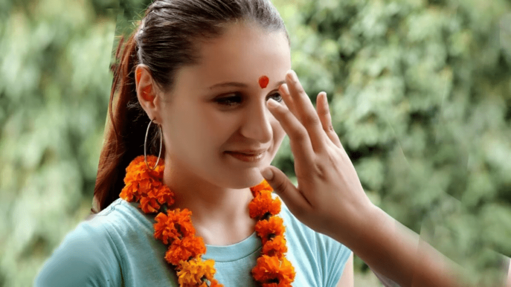 Applying Tilak or Bindi on forehead